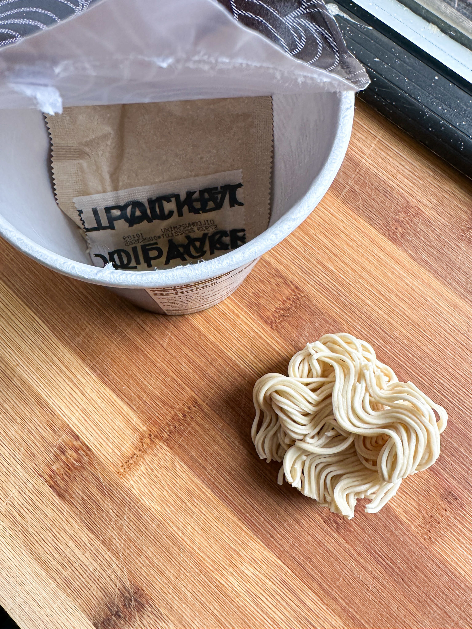 very comically tiny ball of dried noodles in the ramen cup