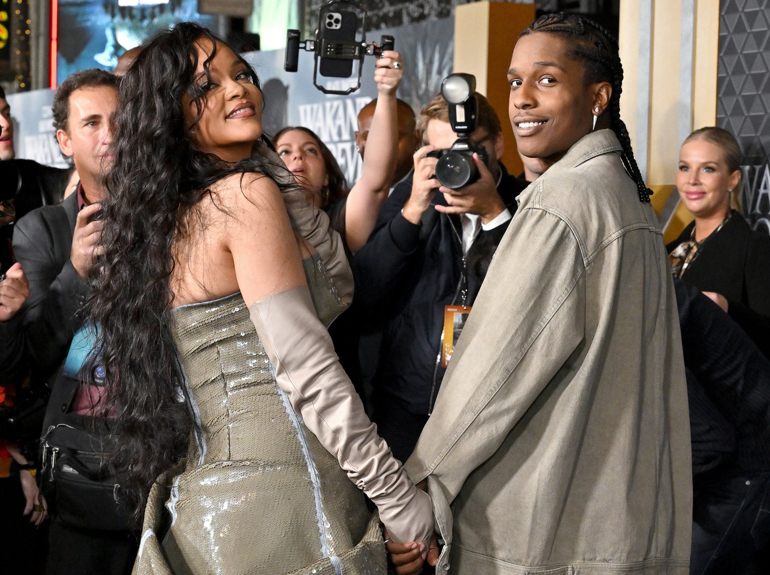 A close-up of Rihanna and A$AP holding hands