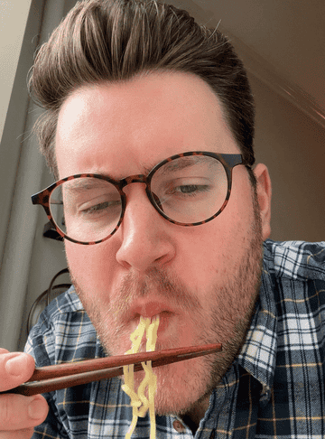 author slurping up instant noodles