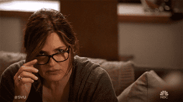 Olivia Benson taking off her glasses, looking confused as the words &quot;dun dun&quot; flash near her head.