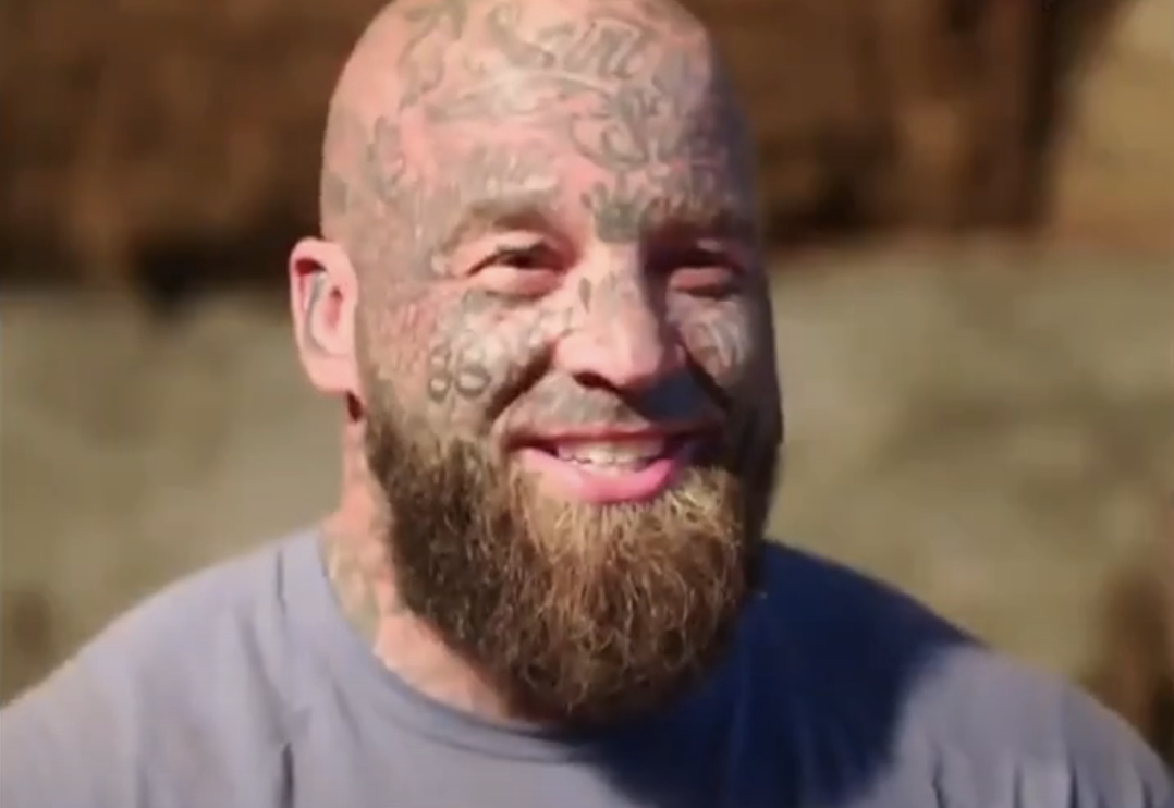 closeup of the man&#x27;s tattooed face