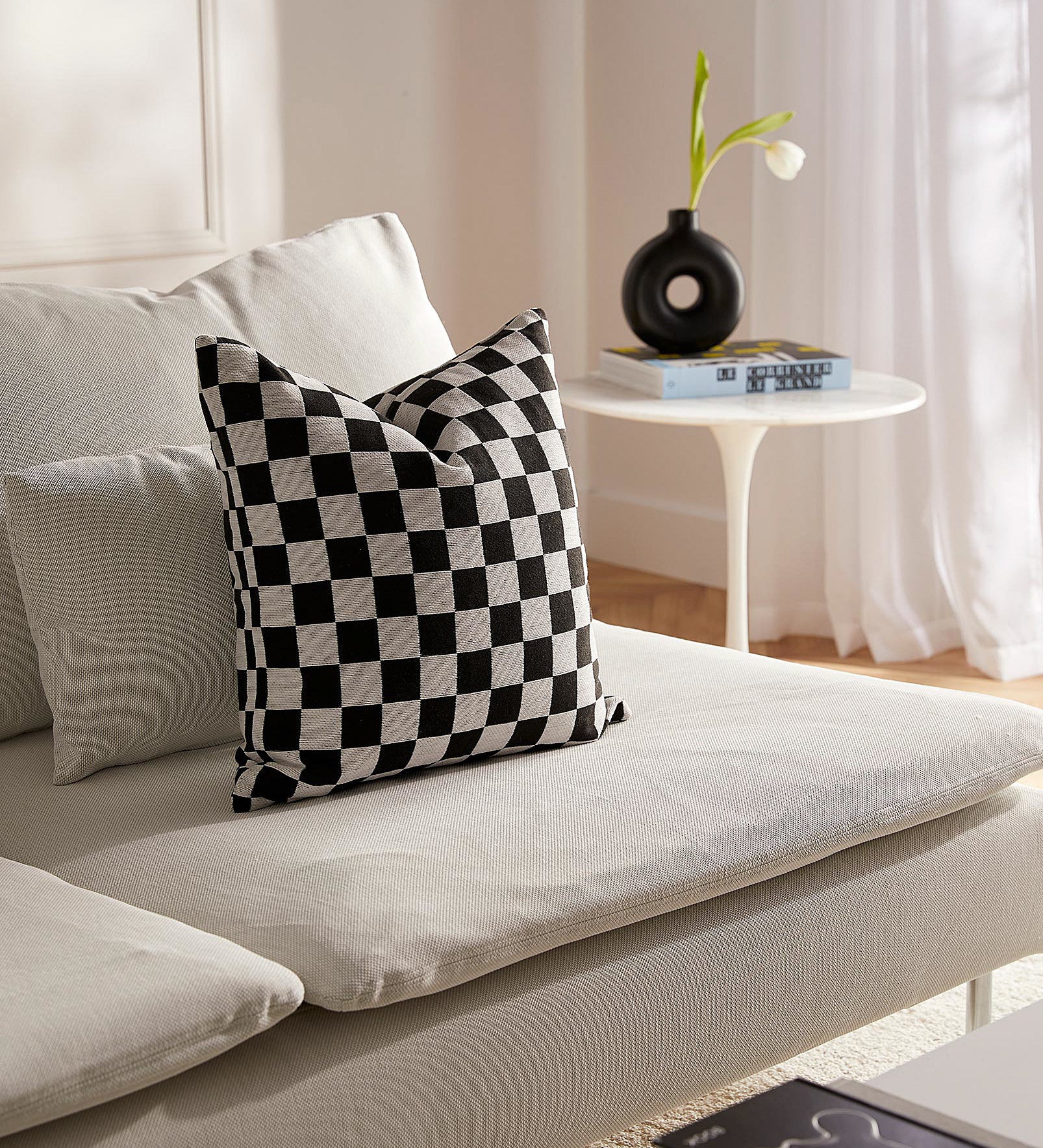the checkered pillow on a couch