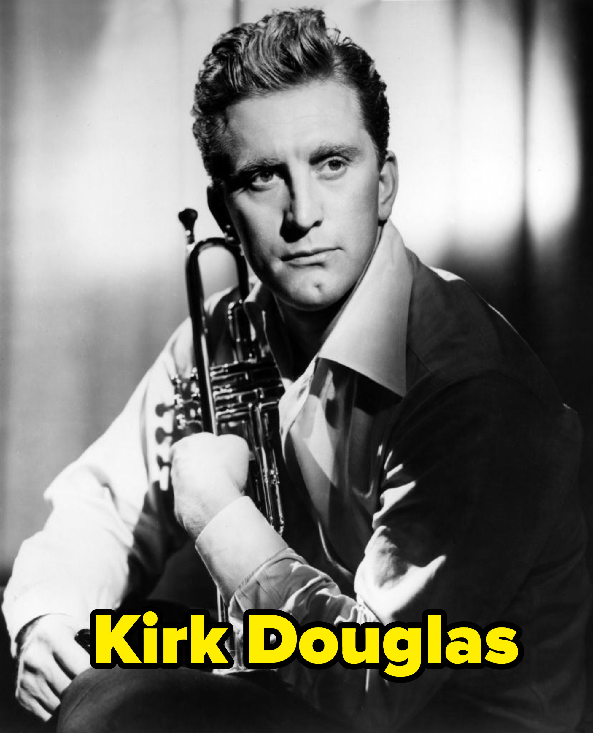 Kirk Douglas holding a trumpet