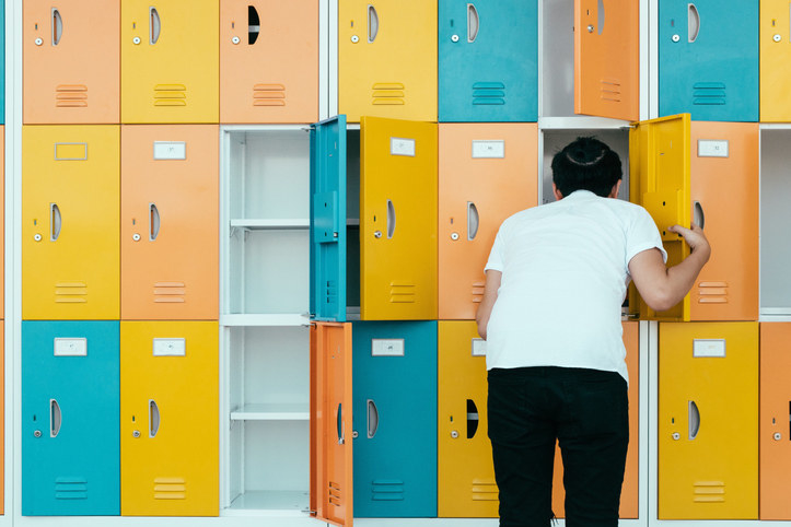 teen looking into his locker