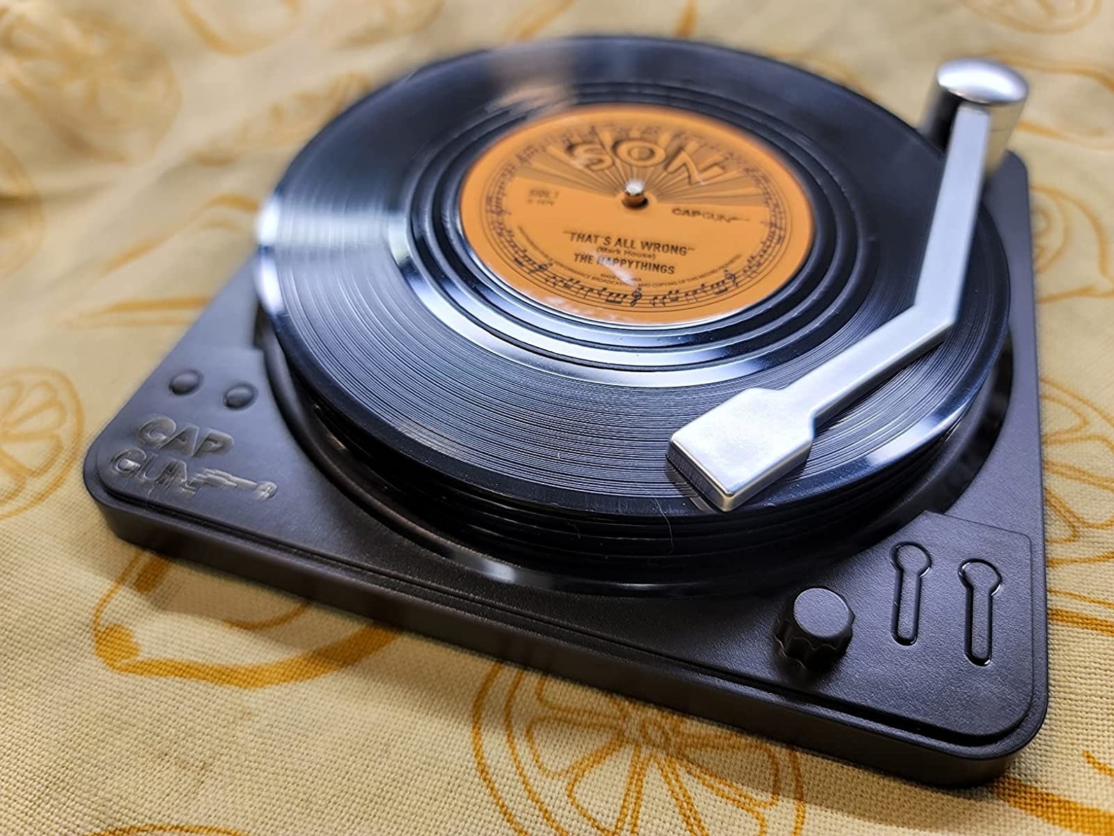 the set of coasters on a record player stand