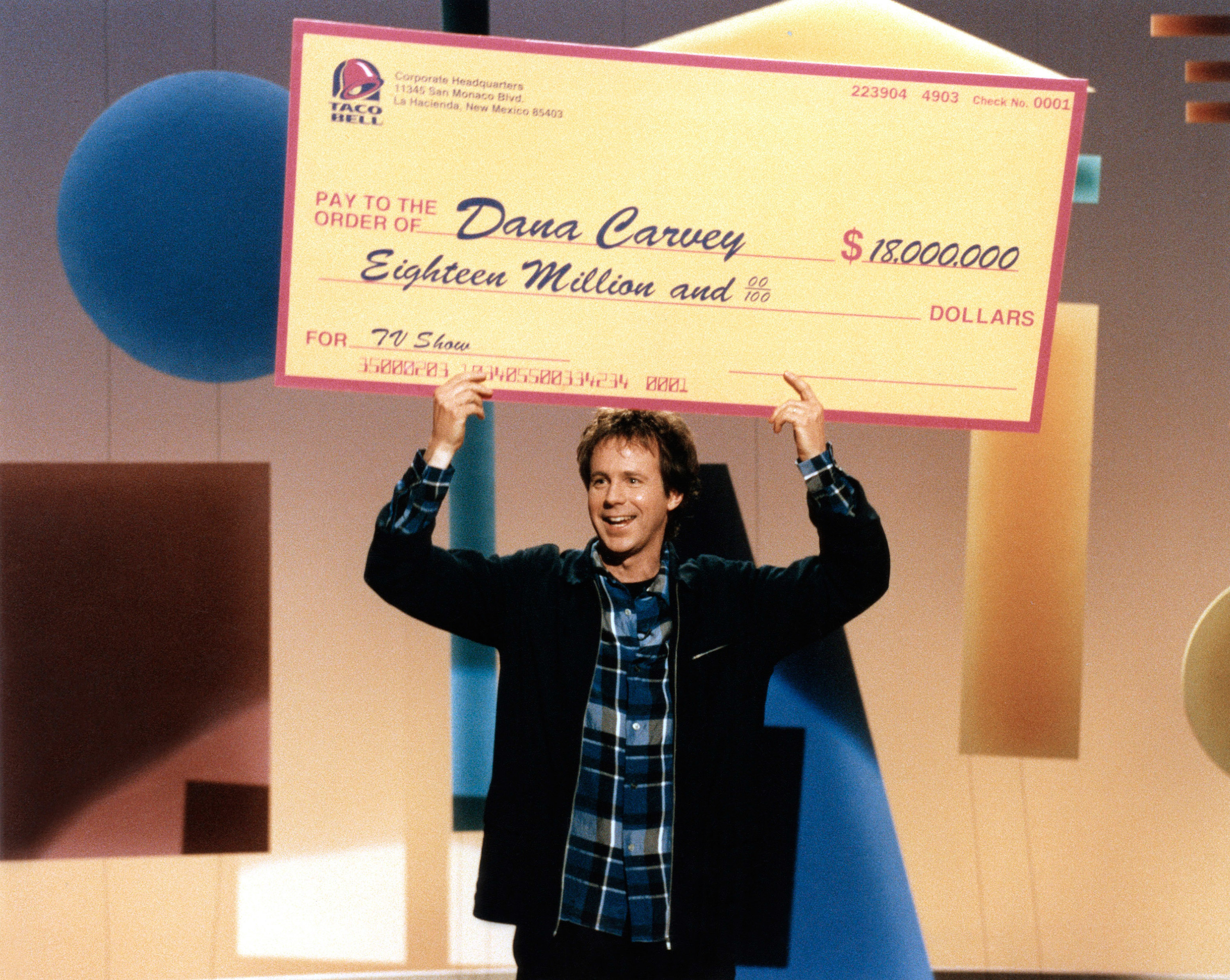 dana carvey holding up a check for 18 million