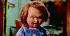 Chucky the doll laughs maniacally with a knife in his hand