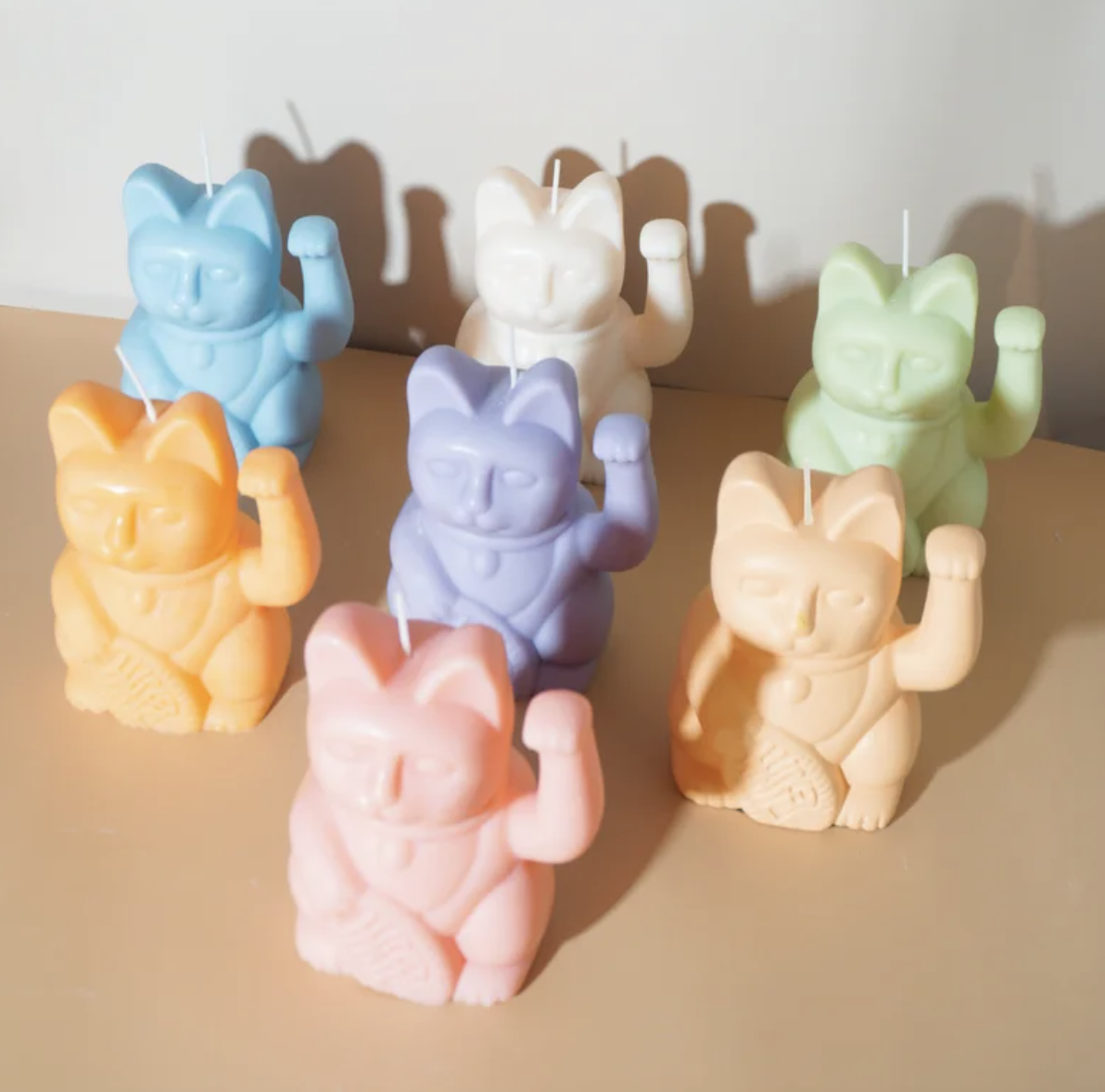 Various colored lucky cat shaped candles