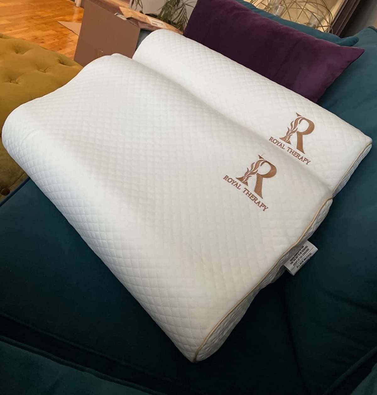 Reviewer image of two memory foam pillows on their couch
