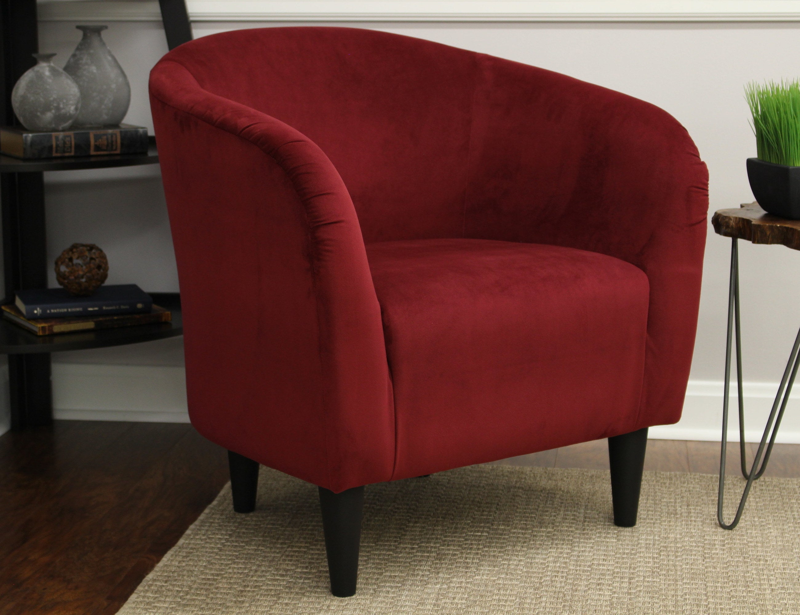 red accent chair with a curved back