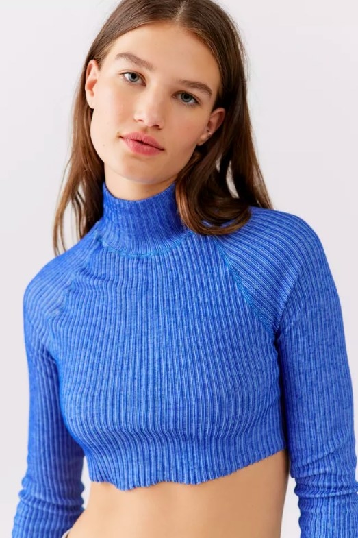 Model wearing blue mock neck top