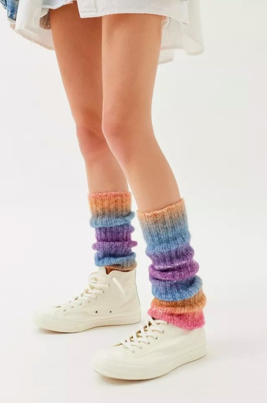 Model wearing colorful leg warmers and white sneakers
