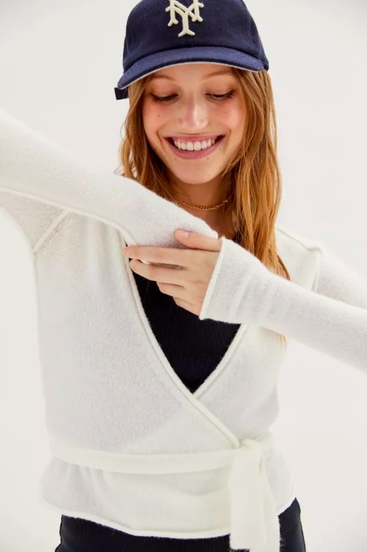 Model wearing white wrap cardigan