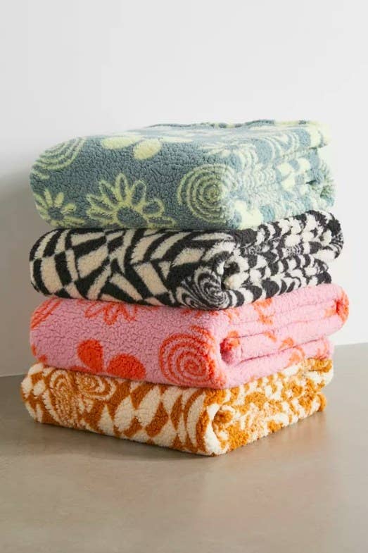 Four colorful folded blankets