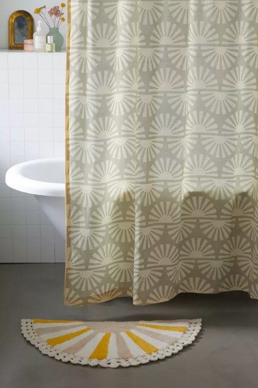 Bath mat next to shower curtain