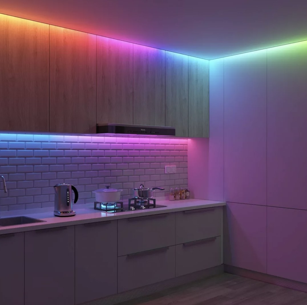a kitchen illuminated by an LED light strip