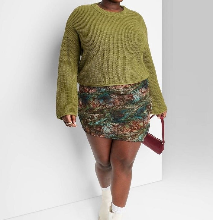 model in olive green cropped boxy ribbed sweater