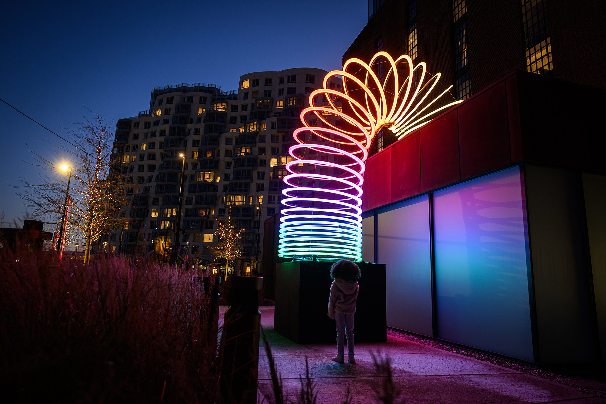 A gigantic neon slinky at night