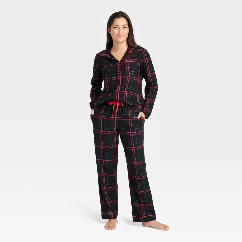A model wearing the PJs in green and red plaid