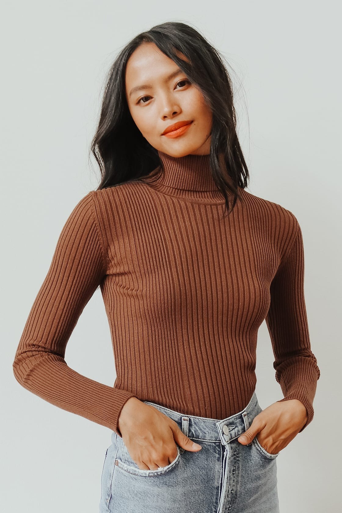 Model wearing the brown turtleneck with jeans