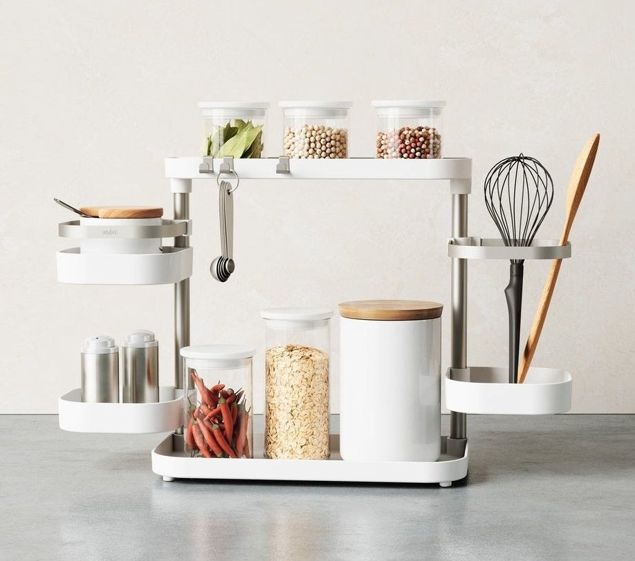 a multi-tiered kitchen organizer filled with kitchen essentials like spices and utensils