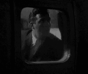 Gif of a character in &quot;The Twilight Zone&quot; looking out a window in shock