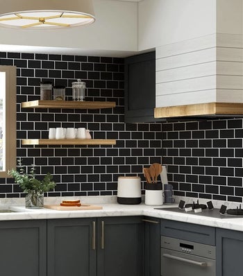 The tiles in black installed on a kitchen wall