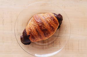 chocolate croissant on a clear plate