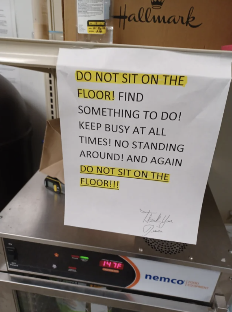 Sign saying &quot;Do not sit on the floor! Find something to do! Keep busy at all times! No standing around, and again, do not sit on the floor!&quot;