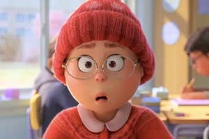 a young girl wears oval glasses and a thick winter hat. her eyes are wide and mouth is in a small O shape. she is 3d animated