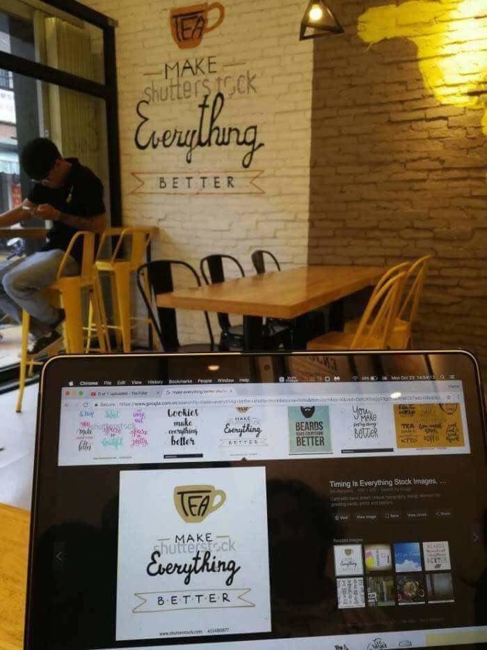 &quot;Make everything better&quot; sign in a café with &quot;Shutterstock&quot; in the background