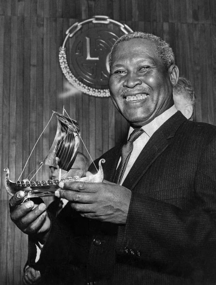 Albert Lutuli poses in Oslo with a silver replica of a Viking ship