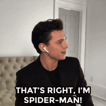 tom holland wears a suit and sits in a living room. he says &quot;that&#x27;s right, i&#x27;m spider-man!&quot;