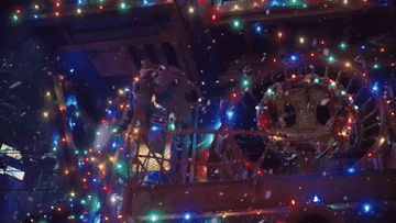 star-lord looks up at the ceiling in a room filled with christmas lights