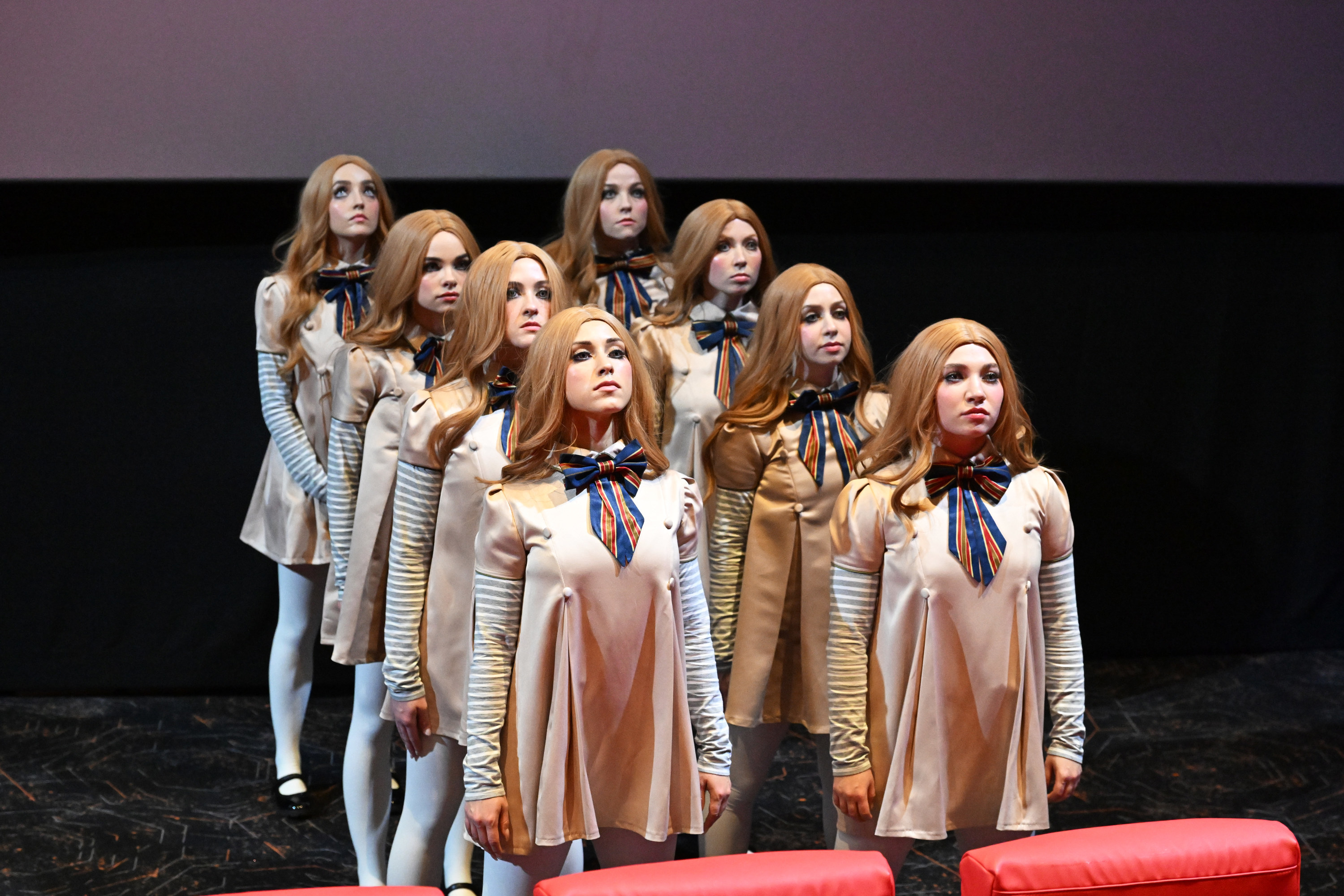 An image showing 8 people dressed as M3GAN dolls