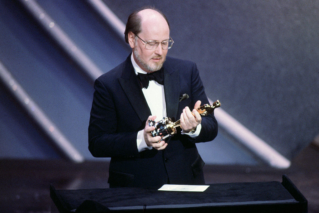 John Williams holding an Oscar