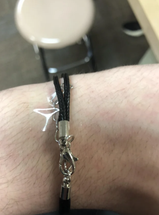 Someone with tape on their bracelet