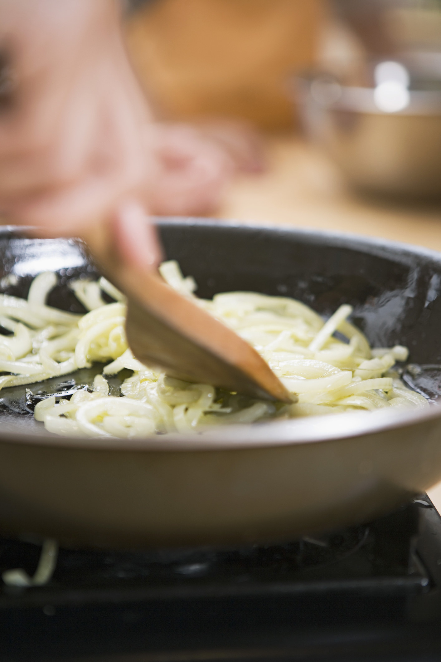 Onions sautéing in a skillet.