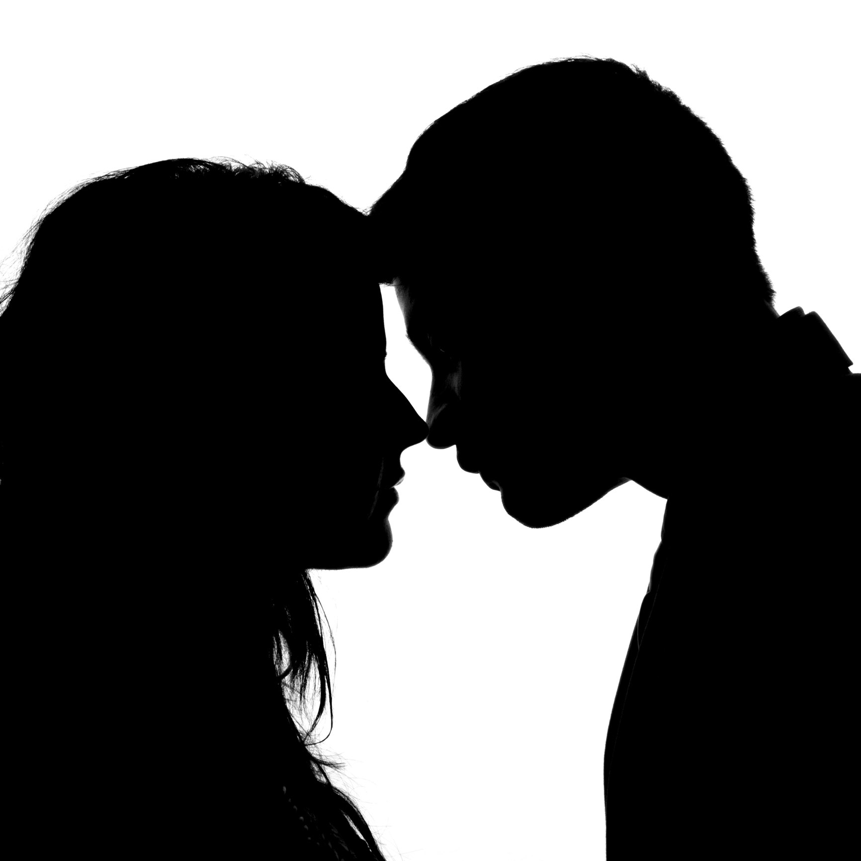 Silhouettes of a couple facing each other
