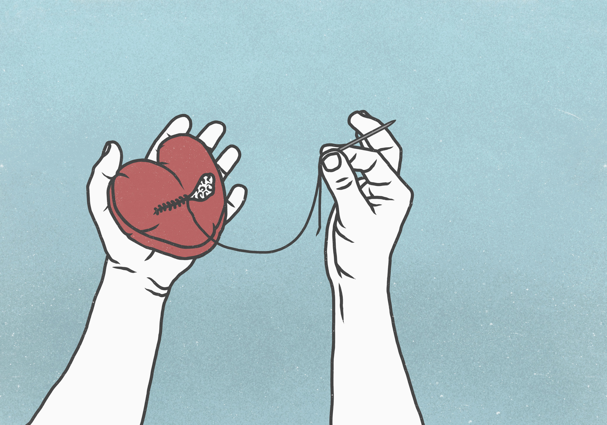 Hands holding a sewing needle and heart