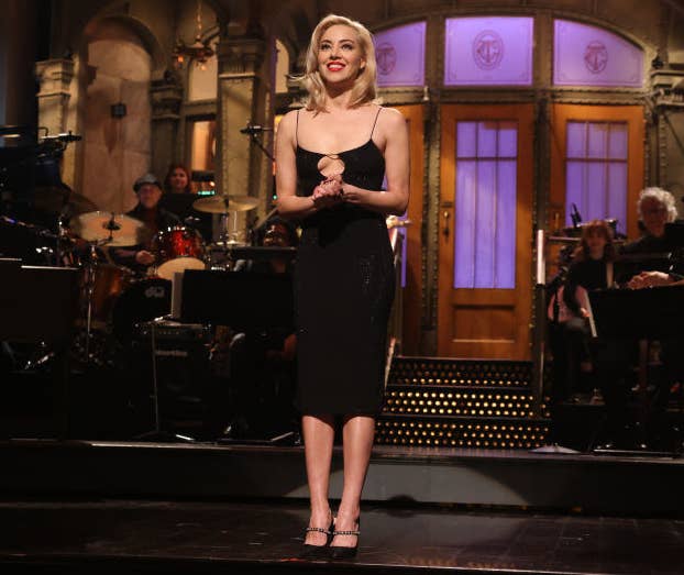 Aubrey Plaza smiles as she stands in front of the audience during her SNL intro monologue