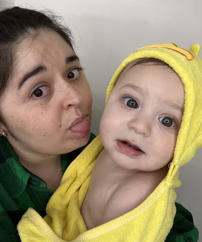 a photo of editor heather braga and her son in a duck towel