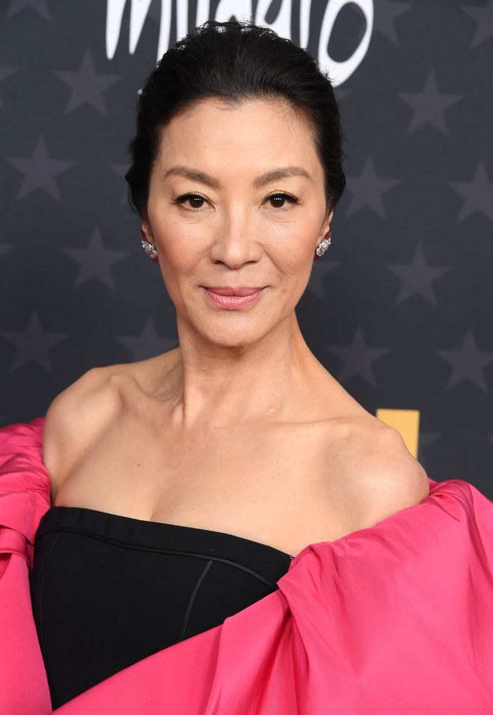 Yeoh poses on the red carpet wearing an off-the-shoulder gown with balloon sleeves