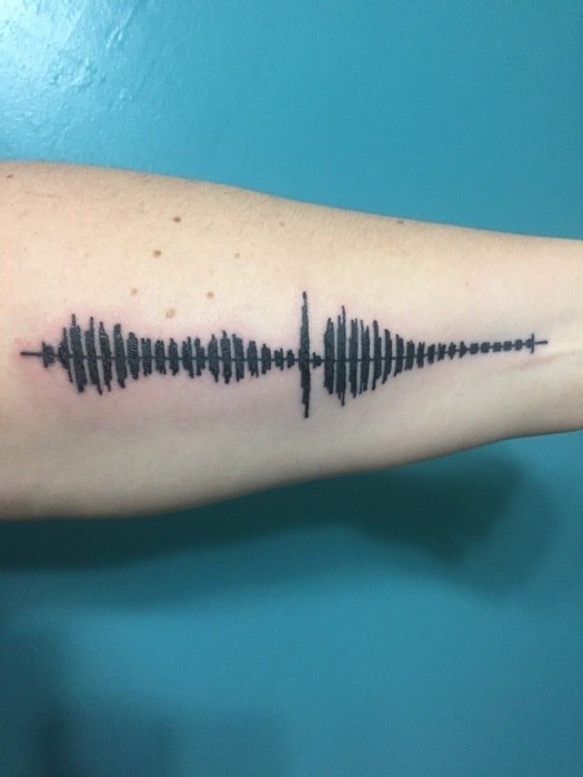 tattoo of a sound wave on inner arm