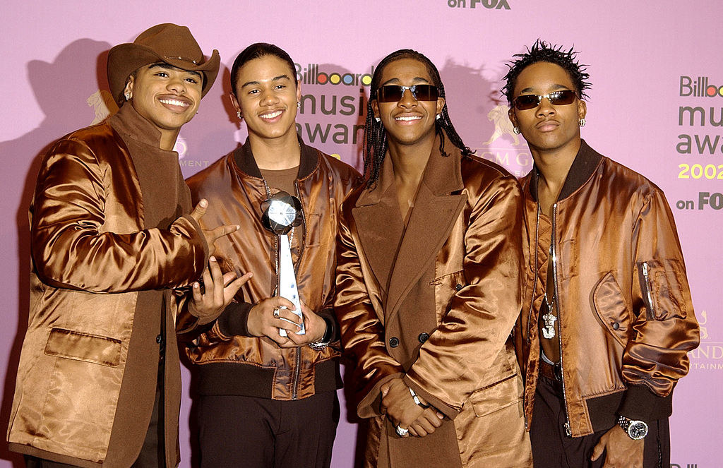 B2K wearing matching satin jackets as they hold their BillBoard Music Award backstage