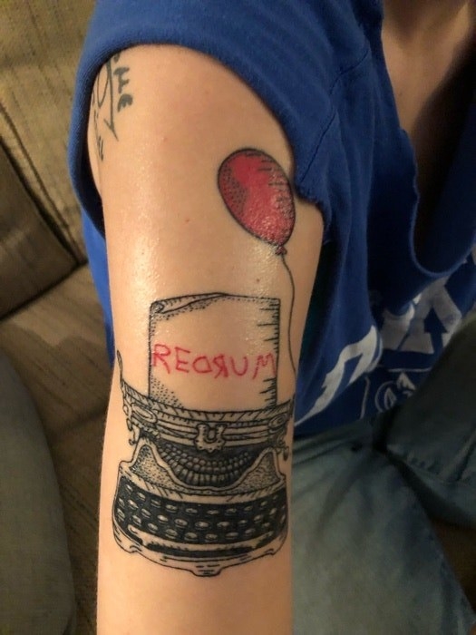 Tattoo of a typewriter with &quot;REDRUM&quot; and a red balloon