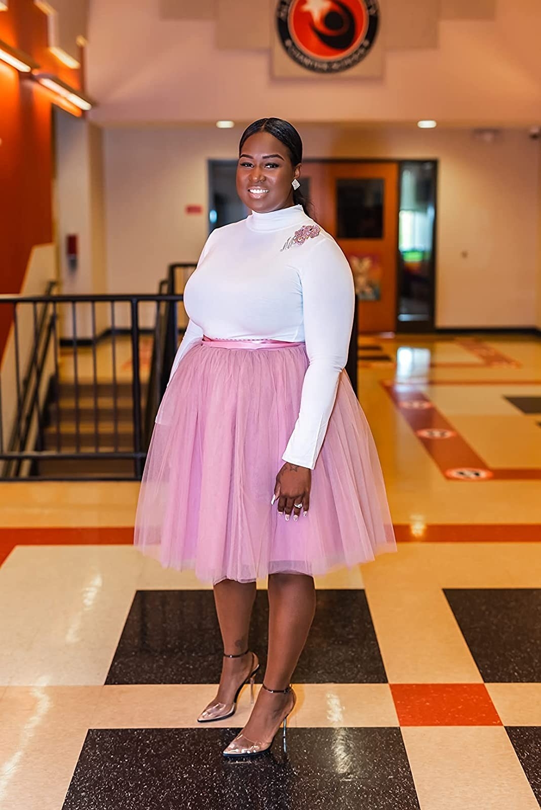 reviewer wearing pink tulle skirt with a white long-sleeve fitted top