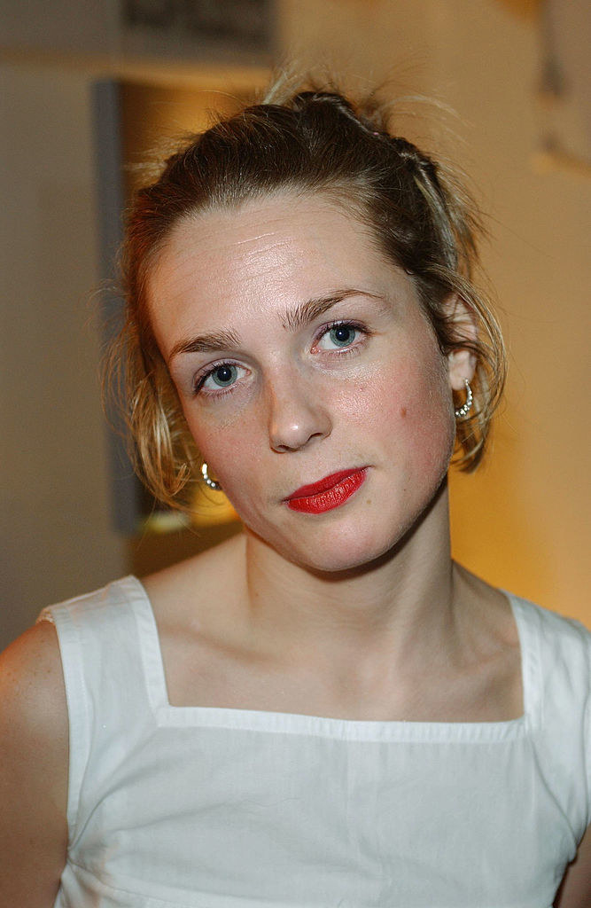 A closeup of Condon in a linen outfit and her hair in a bun