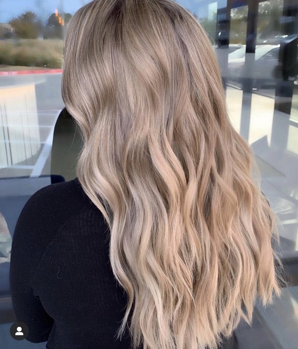 A person with blonde hair showing off their hair post-treatment