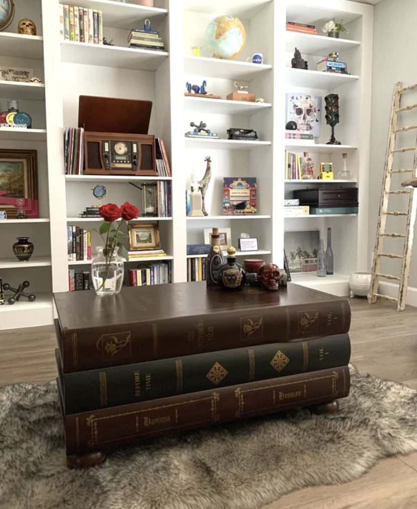 A coffee table shaped like a bag of books